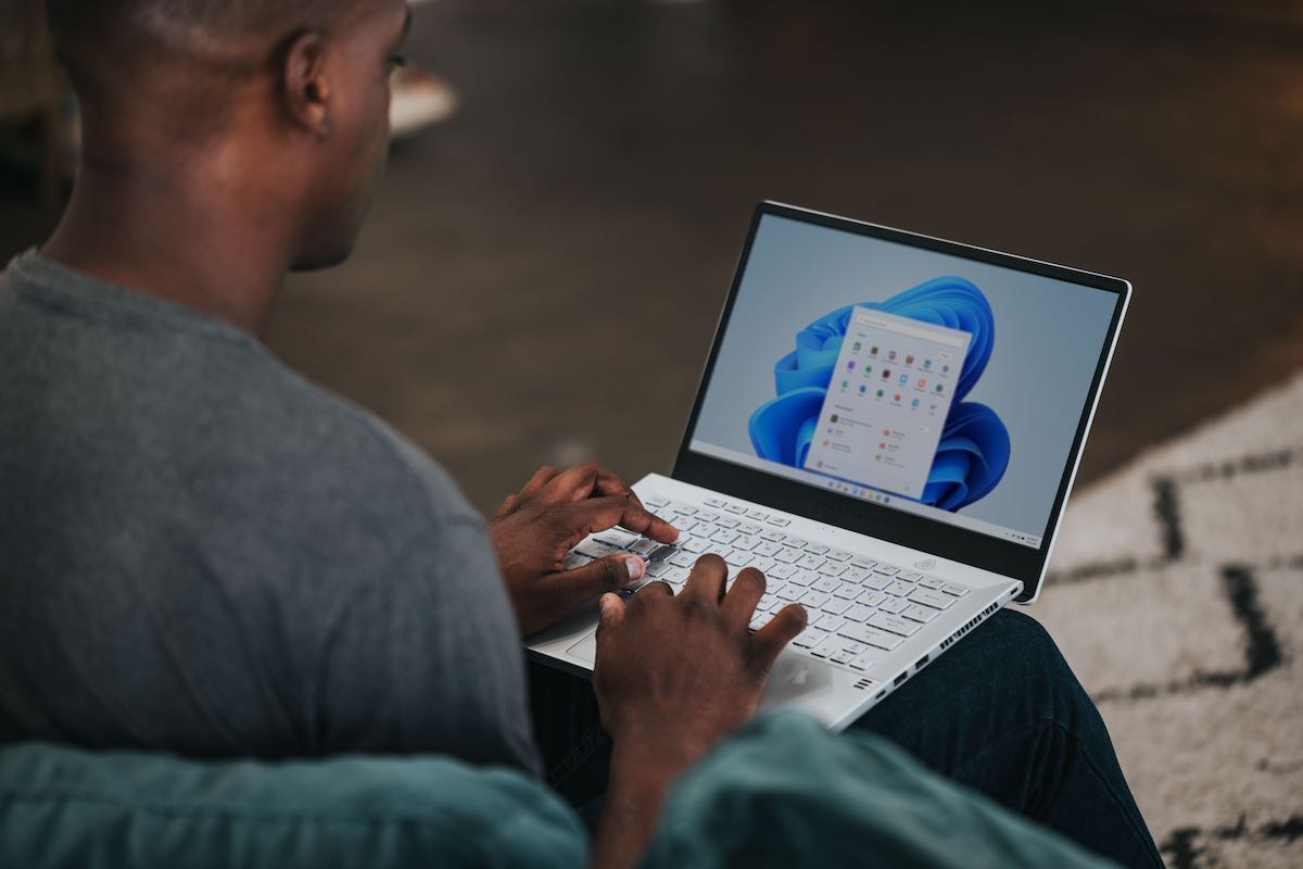 Man sitting with laptop on his lap Microsoft app onscreen.jpg
