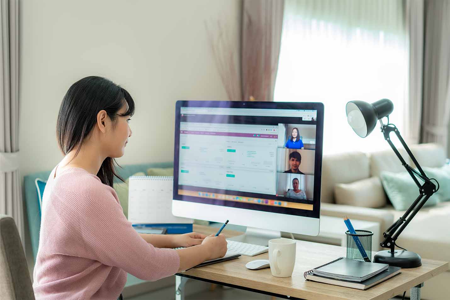 Woman working from home at her computer in an online meeting.jpg